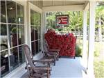 Rocking chairs and the Good Sam sign on the porch at LAKE JASPER RV VILLAGE - thumbnail