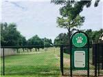 Fenced, grassy dog park at PECAN GROVE RV RESORT - thumbnail