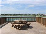 A table and seats on the bridge in the lake at TEXAS LAKESIDE RV RESORT - thumbnail