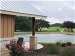 View of lake with golf course in background at ALSATIAN RV RESORT & GOLF CLUB - thumbnail