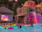 Guest watching a movie from the swimming pool at MOOSE HILLOCK CAMPING RESORT NY - thumbnail
