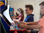 Kids playing the arcade games at PALMETTO SHORES RV RESORT - thumbnail