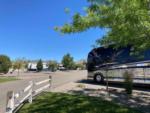 A motorhome in a paved RV site at NEW FRONTIER RV PARK - thumbnail