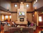 People watching the TV above the fireplace in the main room at NEW FRONTIER RV PARK - thumbnail