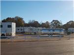 RV park behind a white wooden fence at BATESVILLE CIVIC CENTER RV PARK - thumbnail