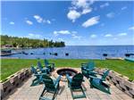 Chairs surrounding fire pit near water at PINES OF KABETOGAMA RESORT - thumbnail