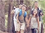 A family hiking thru a forest at BRIGHTON RV RESORT - thumbnail