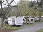 A row of trailers parked in gravels sites at LEMON COVE VILLAGE RV PARK - thumbnail