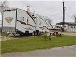 A fifth wheel trailer in a paved RV site at MISSION CITY RV PARK - thumbnail