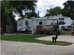 Fifth wheel trailer parked in a gravel site at MISSION CITY RV PARK - thumbnail