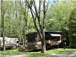 A motorhome in a back in paved RV site at MAPLEWOOD ACRES RV PARK - thumbnail