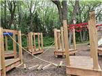 Wooden playground equipment at MAPLEWOOD ACRES RV PARK - thumbnail