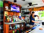 A bartender making a drink at the outside bar at SWAN BAY RESORT - thumbnail