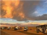 A row of trailers parked in paved sites at sunset at ROUTE 66 RV RESORT - thumbnail