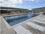 The swimming pool with lounge chairs at THE VINEYARDS OF FREDERICKSBURG RV PARK - thumbnail
