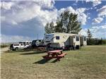 Fifth-wheel on ample site with picnic bench at SLEEPING WOLF CAMPGROUND & RV PARK - thumbnail