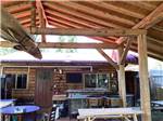 An outdoor seating area and kitchen at THE HEMLOCKS RV AND LODGING - thumbnail