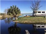 A motorhome next to the water at SPORTSMAN'S COVE RESORT - thumbnail