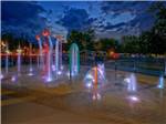 The splash pad lit up at night at RIVEREDGE RV PARK & CABIN RENTALS - thumbnail