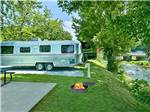 A row of RV sites by the river at RIVEREDGE RV PARK & CABIN RENTALS - thumbnail
