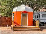 A small orange and white building at CRAZY HORSE RV RESORT - thumbnail