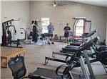 Two men holding weights in the exercise room at KEYSTONE HEIGHTS RV RESORT - thumbnail