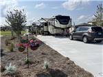 A car and trailers backed in at a RV site at KEYSTONE HEIGHTS RV RESORT - thumbnail