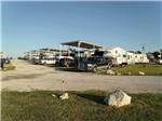 Trailers camping under a blue sky at WEST GATE RV PARK - thumbnail