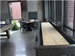 The indoor shuffleboard table at WANDERLUST CROSSINGS RV PARK - thumbnail