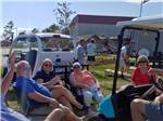 Friends gathered in camping chairs at NMB RV RESORT AND DRY DOCK MARINA - thumbnail