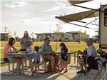 A family eating at their RV site at NORTHERN QUEST RV RESORT - thumbnail