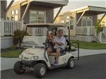 A couple driving a golf cart at NORTHERN QUEST RV RESORT - thumbnail