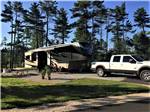 Fifth-wheel with truck on paved site at MANISTIQUE LAKESHORE CAMPGROUND - thumbnail
