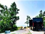 A Winnebago Tour parked next to the water at MANISTIQUE LAKESHORE CAMPGROUND - thumbnail