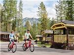 A couple riding their bikes at WEST GLACIER RV PARK & CABINS - thumbnail