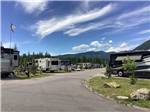 A paved road between RV sites at WEST GLACIER RV PARK & CABINS - thumbnail