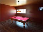 A pool table with red felt top at RAIN SPIRIT RV RESORT - thumbnail