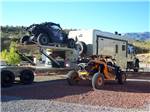 An assortment of off road vehicles at a RV site at RAIN SPIRIT RV RESORT - thumbnail