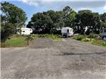 Trailers parked in gravel sites at ALABAMA COAST CAMPGROUND - thumbnail