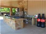 Outdoor kitchen and bar at HIDDEN CREEK RV RESORT - thumbnail