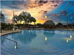 The large swimming pool at dusk at SUNKISSED VILLAGE RV RESORT - thumbnail