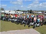 A group of people standing next to bikes at SUNKISSED VILLAGE RV RESORT - thumbnail