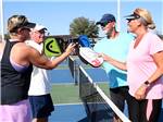 Friends about to play pickleball at SUNKISSED VILLAGE RV RESORT - thumbnail