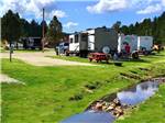 A row of trailers parked by the water at CUSTER CROSSING FAMILY CAMPGROUND - thumbnail