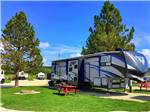 A fifth wheel trailer in a gravel site at CUSTER CROSSING FAMILY CAMPGROUND - thumbnail