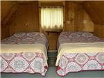 Two beds inside the rental cabin at CUSTER CROSSING FAMILY CAMPGROUND - thumbnail