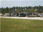 A row of motorhomes parked in gravel sites at CUSTER CROSSING FAMILY CAMPGROUND - thumbnail