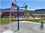 The splash pad next to the playground at CASTLE GATE RV PARK & CAMPGROUND - thumbnail