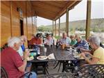 A group of people enjoying food at CASTLE GATE RV PARK & CAMPGROUND - thumbnail