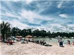 A group of people on the beach at ISLAND OAKS RV RESORT - thumbnail